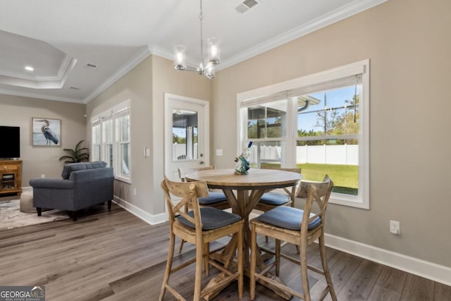 194 Pistachio Ln, Kingsland, GA 31548 - dining space with wood finished floors, crown molding, a chandelier, and baseboards