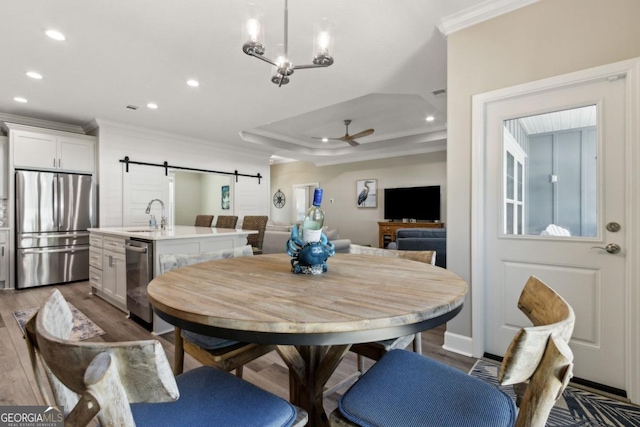 194 Pistachio Ln, Kingsland, GA 31548 - dining area featuring crown molding, a barn door, recessed lighting, a ceiling fan, and wood finished floors