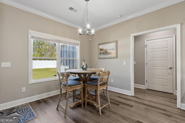 194 Pistachio Ln, Kingsland, GA 31548 - dining space featuring crown molding, wood finished floors, baseboards, and a chandelier