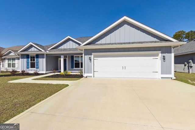 194 Pistachio Ln, Kingsland, GA 31548 - view of front of house with board and batten siding, a garage, driveway, and a front lawn