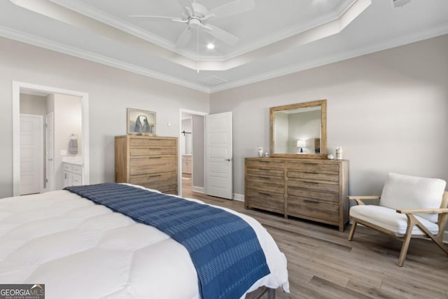 194 Pistachio Ln, Kingsland, GA 31548 - bedroom featuring wood finished floors, a raised ceiling, ornamental molding, ensuite bathroom, and ceiling fan