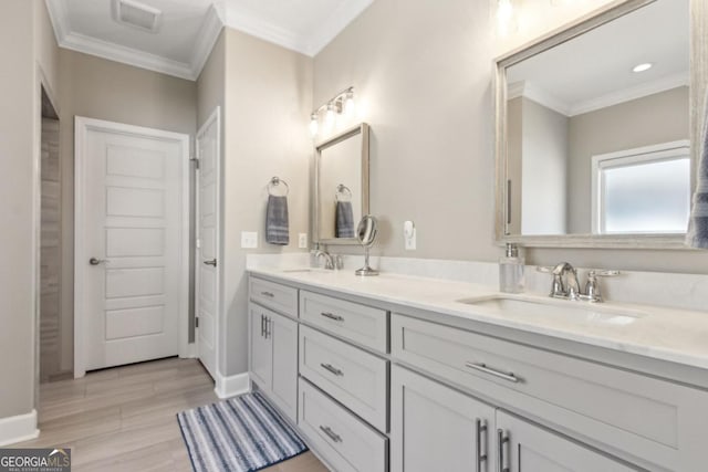 194 Pistachio Ln, Kingsland, GA 31548 - bathroom with double vanity, wood finished floors, ornamental molding, and baseboards