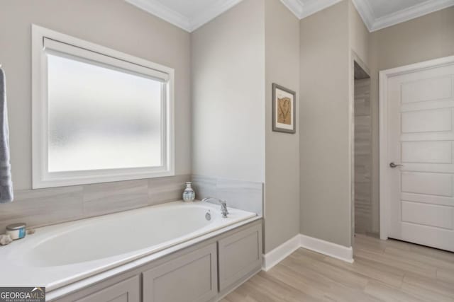 194 Pistachio Ln, Kingsland, GA 31548 - bathroom featuring ornamental molding, a bath, wood finished floors, and baseboards