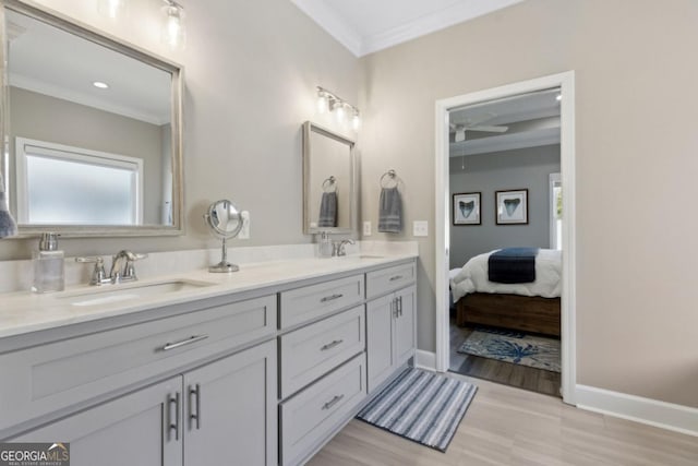 194 Pistachio Ln, Kingsland, GA 31548 - bathroom featuring crown molding, double vanity, baseboards, ceiling fan, and connected bathroom