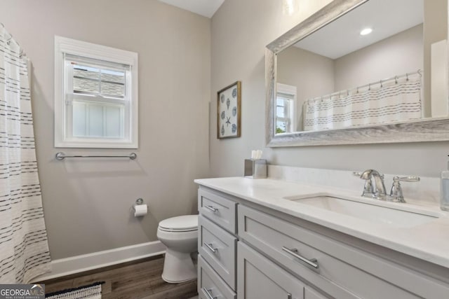 194 Pistachio Ln, Kingsland, GA 31548 - bathroom with vanity, toilet, wood finished floors, baseboards, and curtained shower