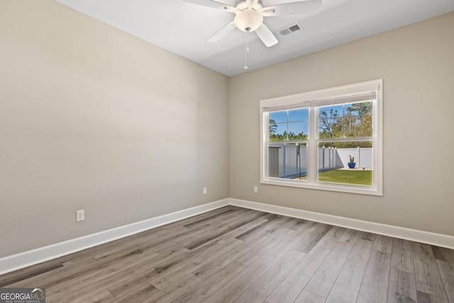 194 Pistachio Ln, Kingsland, GA 31548 - spare room featuring baseboards, wood finished floors, and a ceiling fan