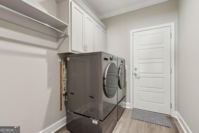 194 Pistachio Ln, Kingsland, GA 31548 - laundry room with washer and clothes dryer, light wood finished floors, baseboards, cabinet space, and ornamental molding