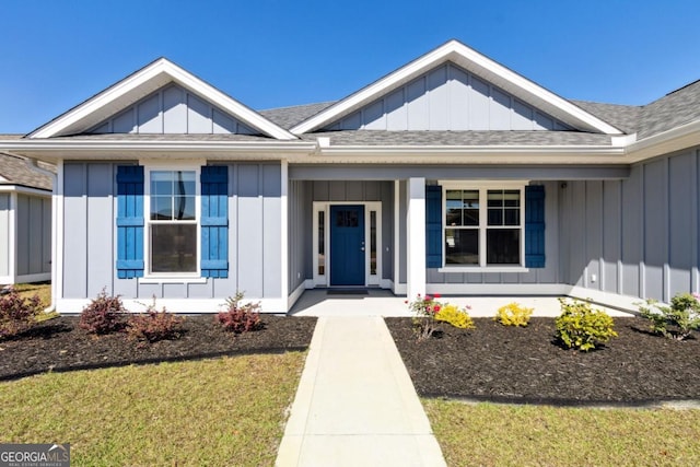 194 Pistachio Ln, Kingsland, GA 31548 - view of front of property featuring board and batten siding, a porch, a shingled roof, and a front yard