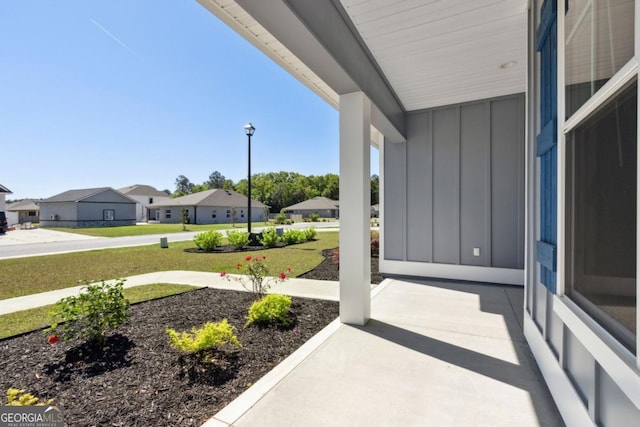 194 Pistachio Ln, Kingsland, GA 31548 - covered porch with a residential view and a lawn