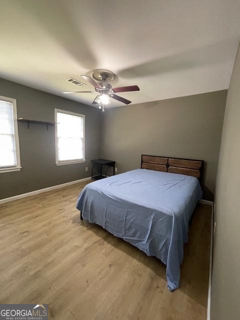 3120 Saint Andrews Cir, Duluth, GA 30096 - bedroom with wood finished floors, baseboards, and a ceiling fan