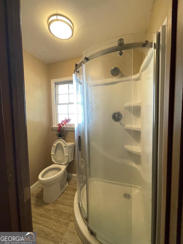 3120 Saint Andrews Cir, Duluth, GA 30096 - bathroom featuring toilet, a shower stall, baseboards, and wood finished floors