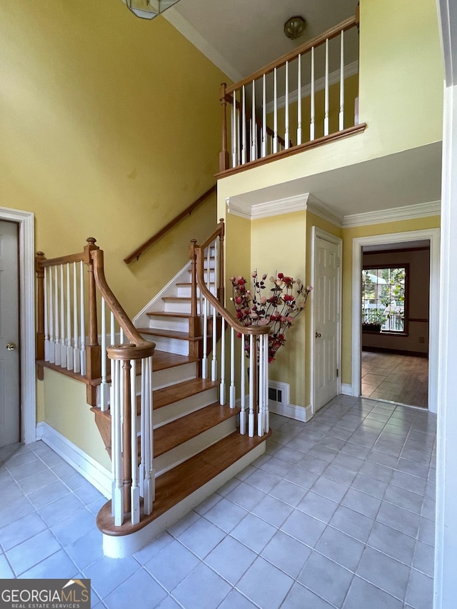 3120 Saint Andrews Cir, Duluth, GA 30096 - stairs with crown molding, high vaulted ceiling, tile patterned floors, and baseboards