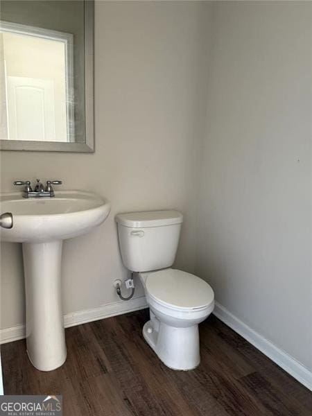 6446 Grey Fox Way, Riverdale, GA 30296 - bathroom with baseboards, wood finished floors, and toilet