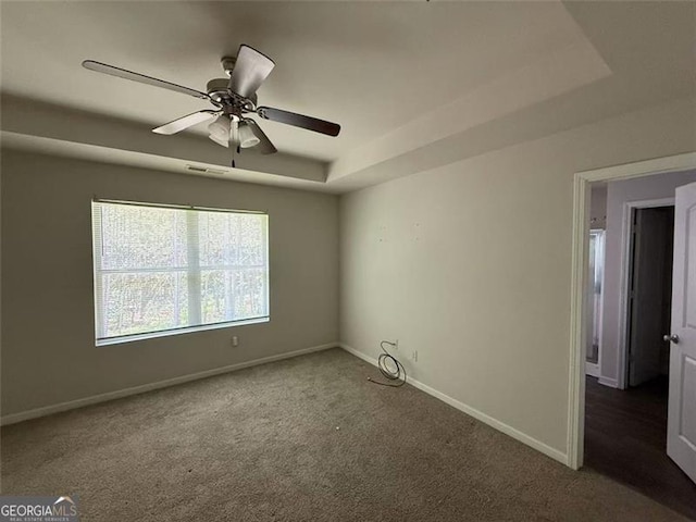 6446 Grey Fox Way, Riverdale, GA 30296 - carpeted spare room with baseboards, a ceiling fan, and a tray ceiling