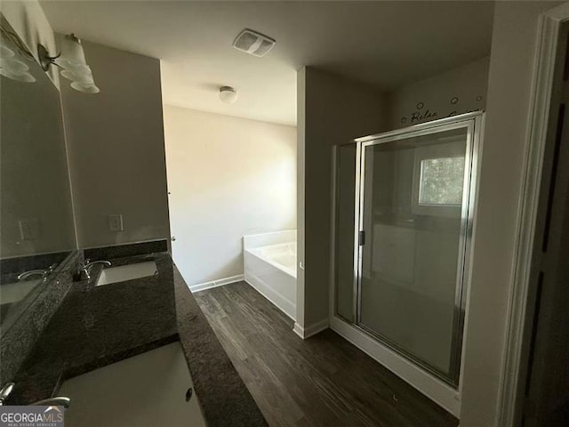 6446 Grey Fox Way, Riverdale, GA 30296 - full bathroom with wood finished floors, a bath, a stall shower, double vanity, and baseboards