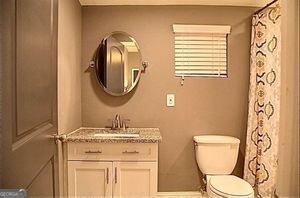 836 Wood St NW, Atlanta, GA 30318 - full bath with vanity and a shower with shower curtain