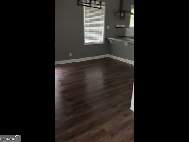 836 Wood St NW, Atlanta, GA 30318 - unfurnished dining area with dark wood-type flooring and a chandelier