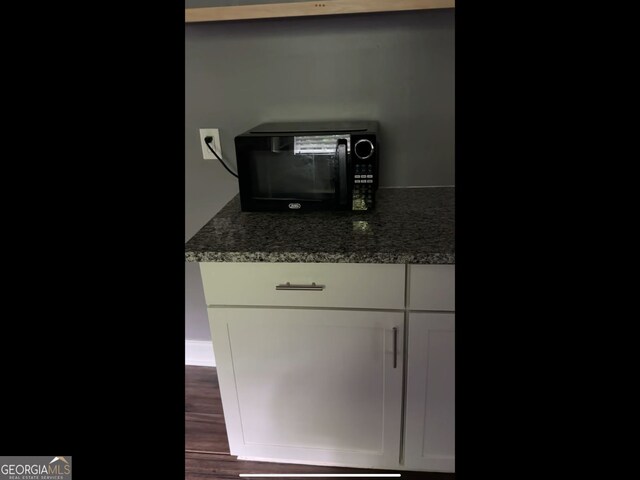 836 Wood St NW, Atlanta, GA 30318 - detailed view of black microwave and wood finished floors
