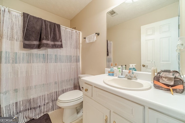 704 Stonecrest Ln, Loganville, GA 30052 - bathroom featuring toilet, vanity, a textured ceiling, a shower with shower curtain, and tile patterned flooring