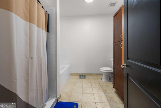 870 Mayson Turner Rd NW Unit 1111, Atlanta, GA 30314 - bathroom featuring toilet, a shower with shower curtain, tile patterned floors, a bath, and baseboards