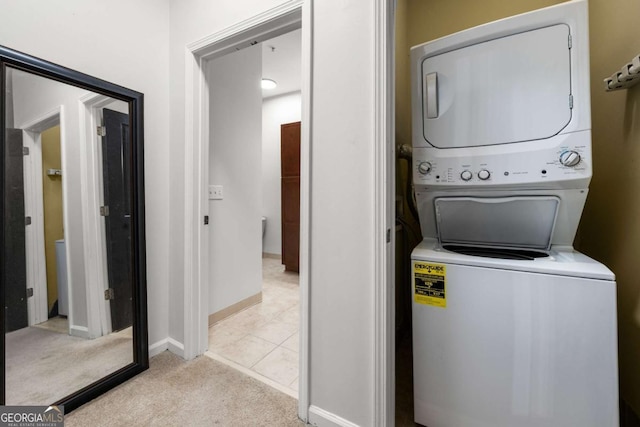870 Mayson Turner Rd NW Unit 1111, Atlanta, GA 30314 - laundry room with stacked washer / drying machine, light carpet, and baseboards