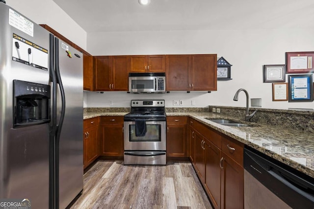 870 Mayson Turner Rd NW Unit 1111, Atlanta, GA 30314 - kitchen with appliances with stainless steel finishes, a sink, light wood finished floors, and stone countertops