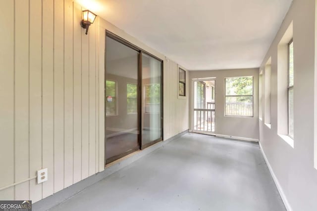 744 Martin Rd, Stone Mountain, GA 30088 - unfurnished sunroom with finished concrete flooring and wooden walls