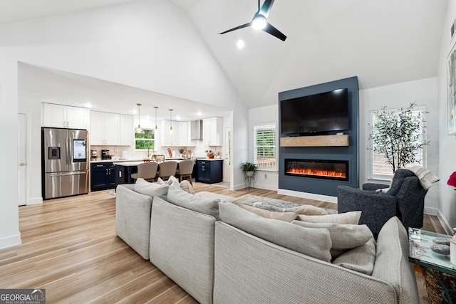6565 Nix Rd, Dawsonville, GA 30534 - living room with high vaulted ceiling, a fireplace, a ceiling fan, light wood finished floors, and recessed lighting