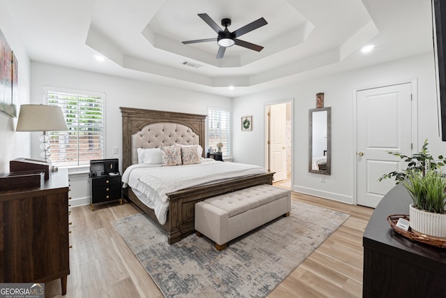 6565 Nix Rd, Dawsonville, GA 30534 - bedroom with a tray ceiling, multiple windows, light wood finished floors, and ceiling fan