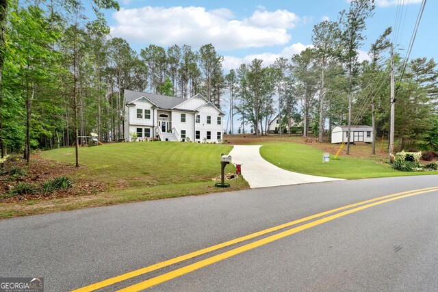 6565 Nix Rd, Dawsonville, GA 30534 - view of front facade with board and batten siding, concrete driveway, and a front lawn