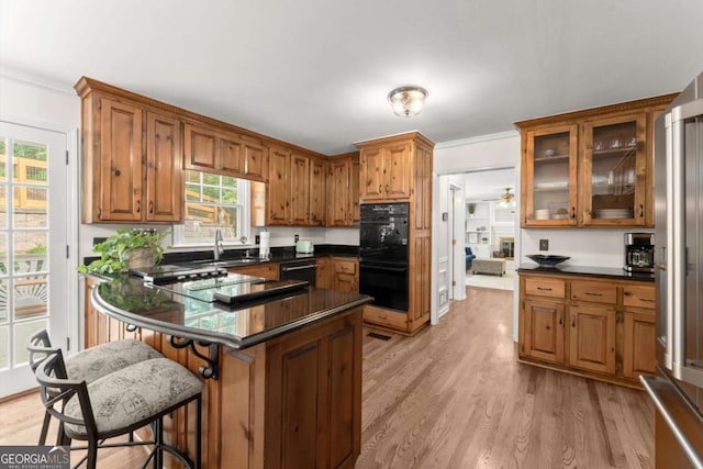 4223 N Mountain Rd NE, Marietta, GA 30066 - kitchen with black appliances, dark countertops, brown cabinetry, and ornamental molding