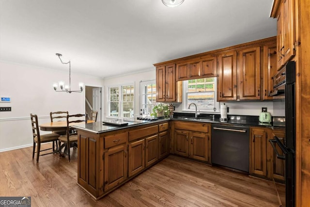 4223 N Mountain Rd NE, Marietta, GA 30066 - kitchen with dishwasher, a sink, dark countertops, a peninsula, and wood finished floors