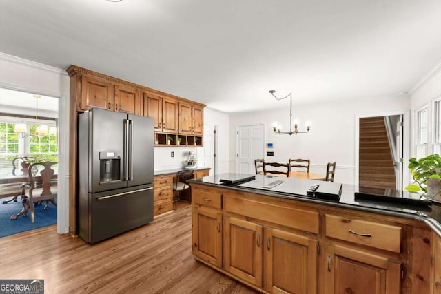 4223 N Mountain Rd NE, Marietta, GA 30066 - kitchen featuring high end fridge, a chandelier, crown molding, brown cabinetry, and light wood-style floors