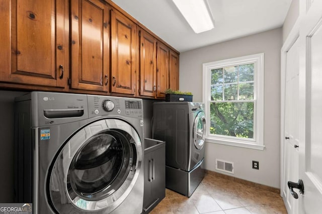 4223 N Mountain Rd NE, Marietta, GA 30066 - washroom with washing machine and clothes dryer, cabinet space, light tile patterned floors, and baseboards