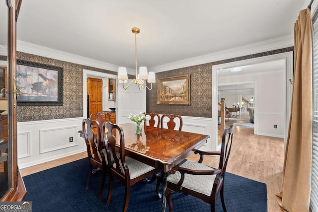 4223 N Mountain Rd NE, Marietta, GA 30066 - dining room featuring a chandelier, wood finished floors, wallpapered walls, wainscoting, and crown molding