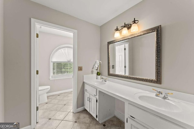 4223 N Mountain Rd NE, Marietta, GA 30066 - bathroom featuring toilet, double vanity, baseboards, and tile patterned flooring
