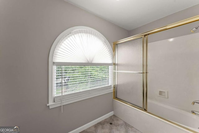 4223 N Mountain Rd NE, Marietta, GA 30066 - full bath featuring shower / bath combination with glass door, tile patterned floors, and baseboards