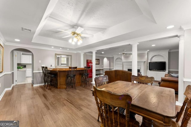 4223 N Mountain Rd NE, Marietta, GA 30066 - dining room with a ceiling fan, a tray ceiling, decorative columns, a bar, and recessed lighting