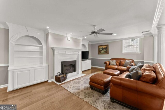 4223 N Mountain Rd NE, Marietta, GA 30066 - living room featuring a ceiling fan, wood finished floors, crown molding, recessed lighting, and a fireplace with flush hearth