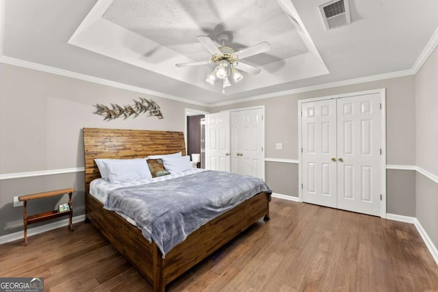 4223 N Mountain Rd NE, Marietta, GA 30066 - bedroom featuring a raised ceiling, two closets, baseboards, wood finished floors, and ceiling fan