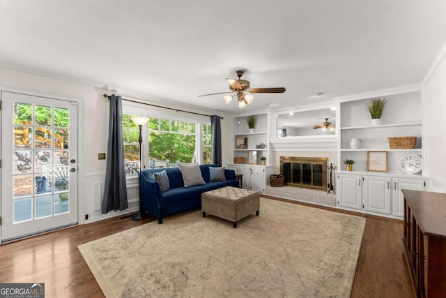4223 N Mountain Rd NE, Marietta, GA 30066 - living room with ceiling fan, healthy amount of natural light, crown molding, a brick fireplace, and dark wood finished floors