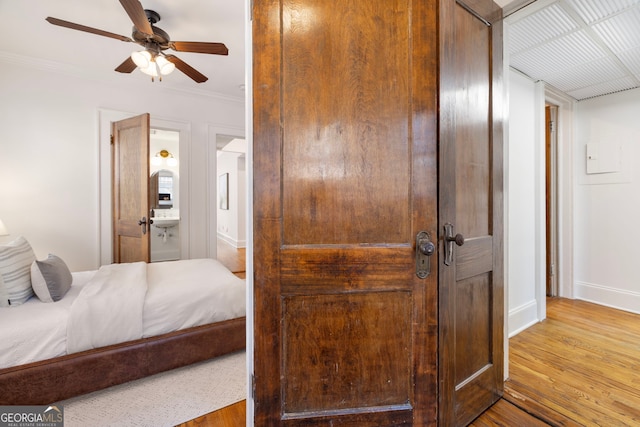 653 N Highland Ave NE Unit 5, Atlanta, GA 30306 - bedroom featuring wood finished floors, ornamental molding, ensuite bath, and ceiling fan
