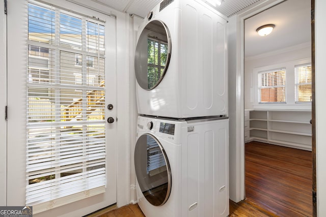 653 N Highland Ave NE Unit 5, Atlanta, GA 30306 - washroom with stacked washing machine and dryer, wood finished floors, ornamental molding, and healthy amount of natural light