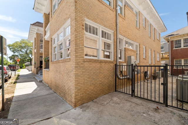 653 N Highland Ave NE Unit 5, Atlanta, GA 30306 - view of side of property with brick siding and a gate