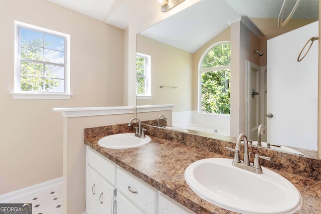 7186 Raintree Loop, Jonesboro, GA 30236 - full bath featuring a garden tub, double vanity, a shower, baseboards, and vaulted ceiling
