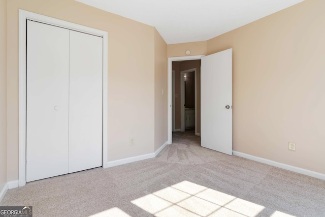 7186 Raintree Loop, Jonesboro, GA 30236 - unfurnished bedroom featuring carpet floors, baseboards, and a closet