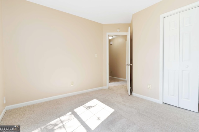 7186 Raintree Loop, Jonesboro, GA 30236 - unfurnished bedroom featuring carpet, a closet, and baseboards