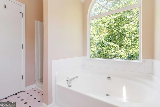 7186 Raintree Loop, Jonesboro, GA 30236 - full bathroom with a bath and baseboards