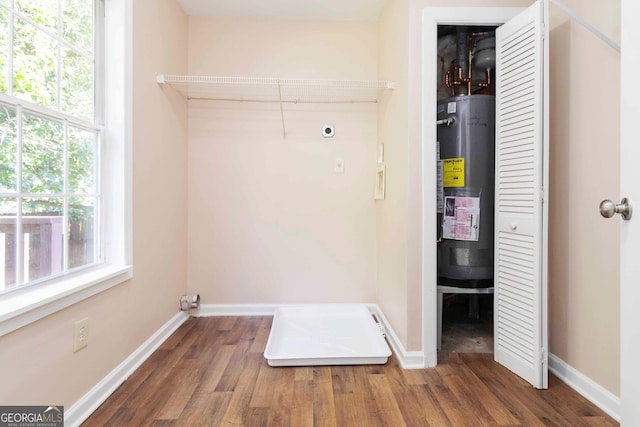 7186 Raintree Loop, Jonesboro, GA 30236 - washroom featuring water heater, electric dryer hookup, wood finished floors, and baseboards