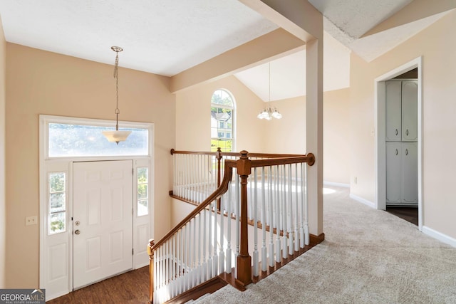 7186 Raintree Loop, Jonesboro, GA 30236 - entryway with vaulted ceiling, a chandelier, baseboards, and carpet flooring